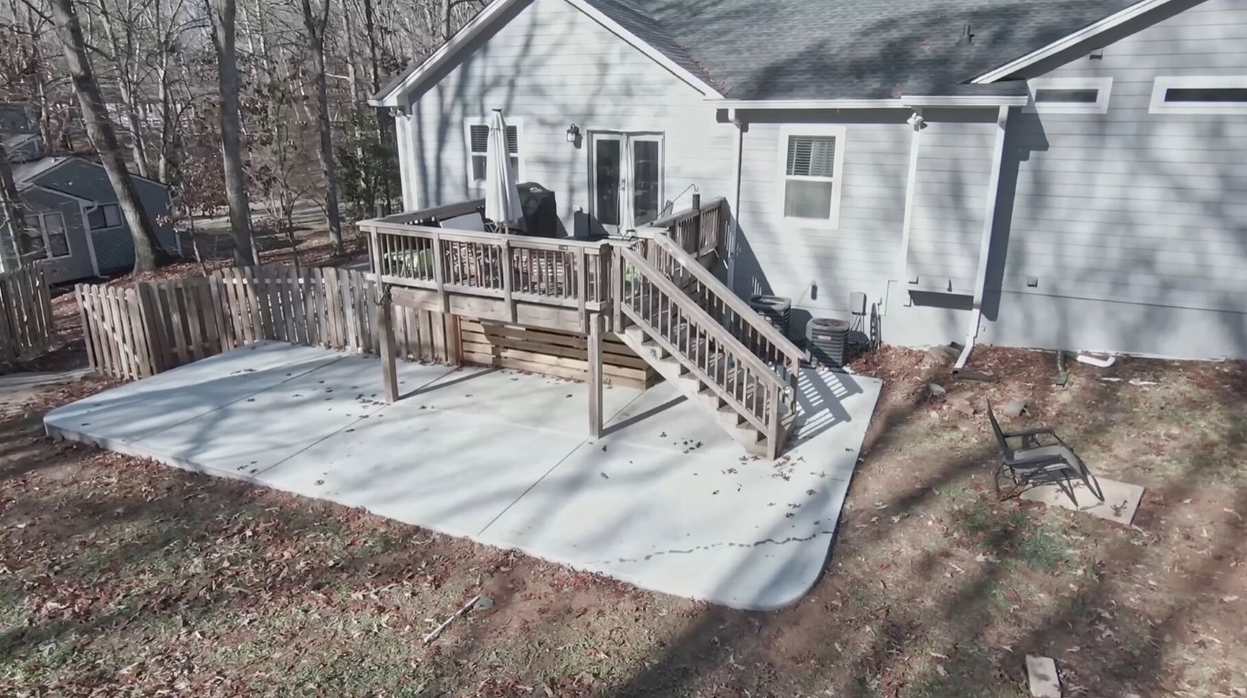 Custom concrete patio with deck access in Palm City, FL